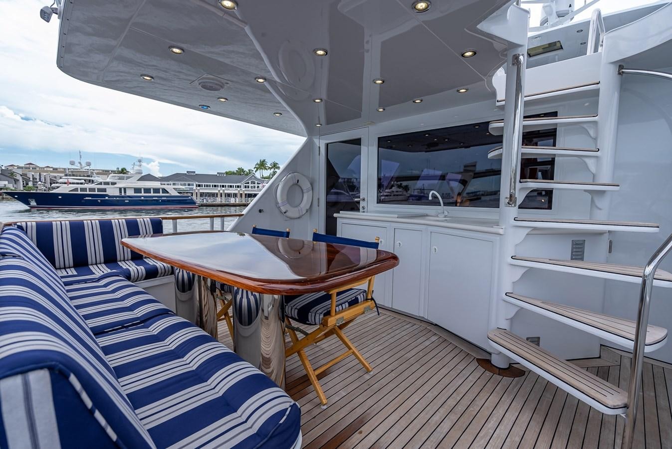 a boat with a table and chairs aboard MY WAY Yacht for Sale