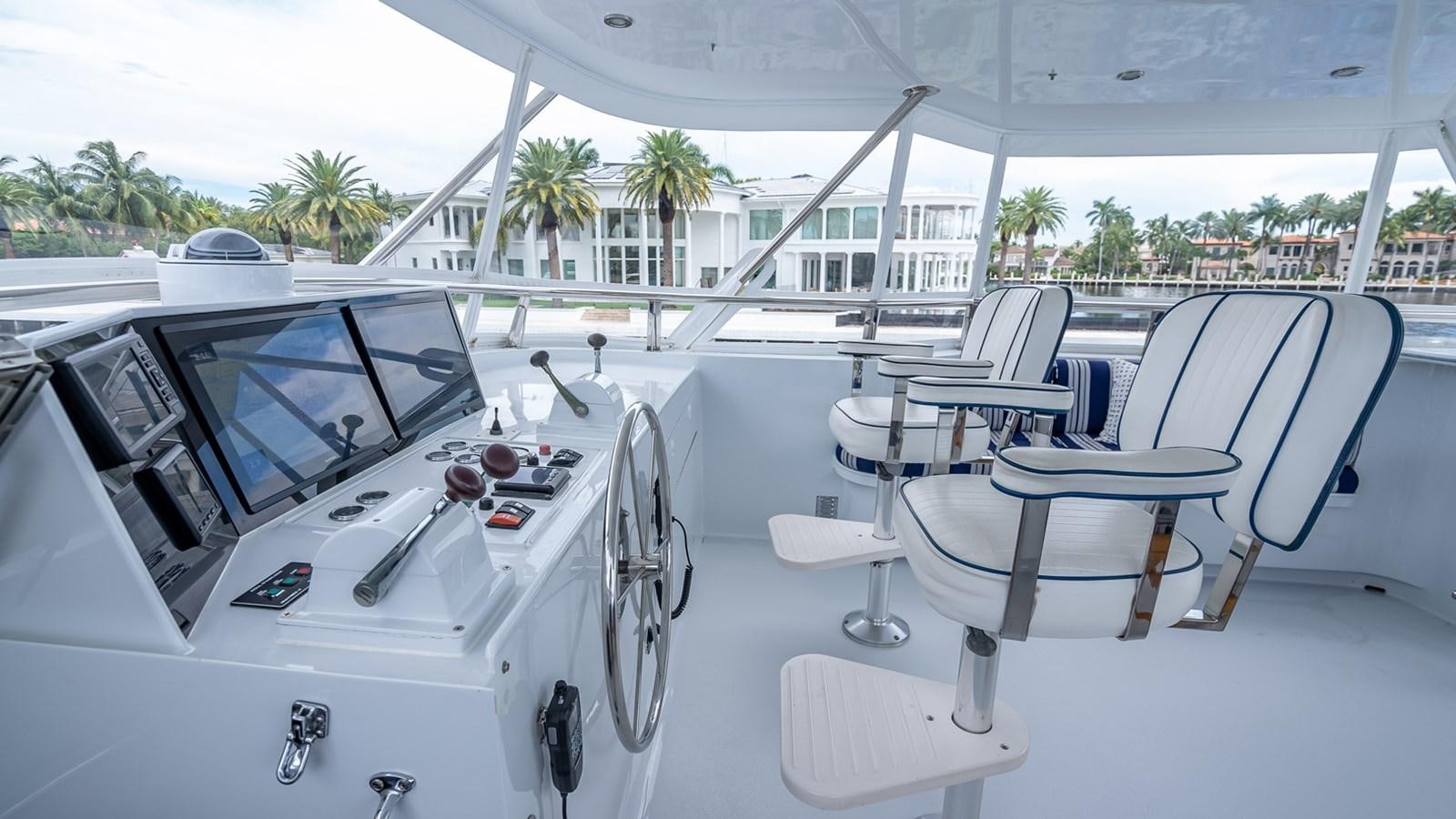 a white yacht with white chairs aboard MY WAY Yacht for Sale