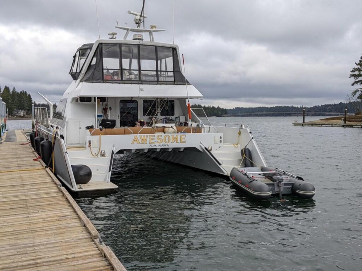 a boat docked at a pier aboard AWESOME Yacht for Sale