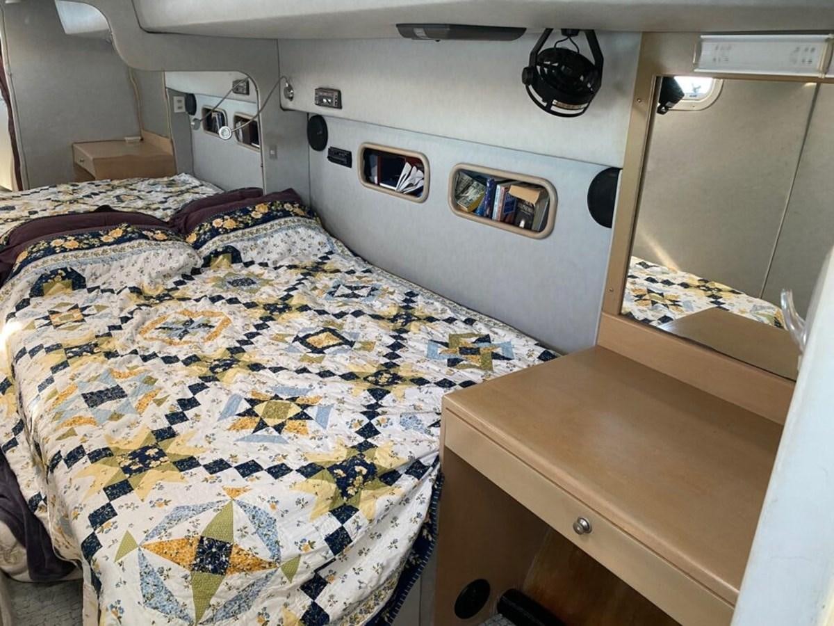 a bedroom with a bed and a desk aboard AWESOME Yacht for Sale