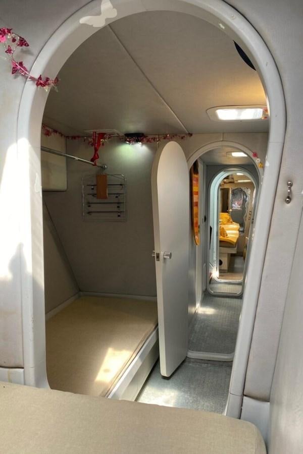 a hallway with a door and a mirror aboard AWESOME Yacht for Sale