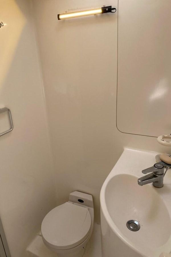 a bathroom with a toilet and sink aboard AWESOME Yacht for Sale