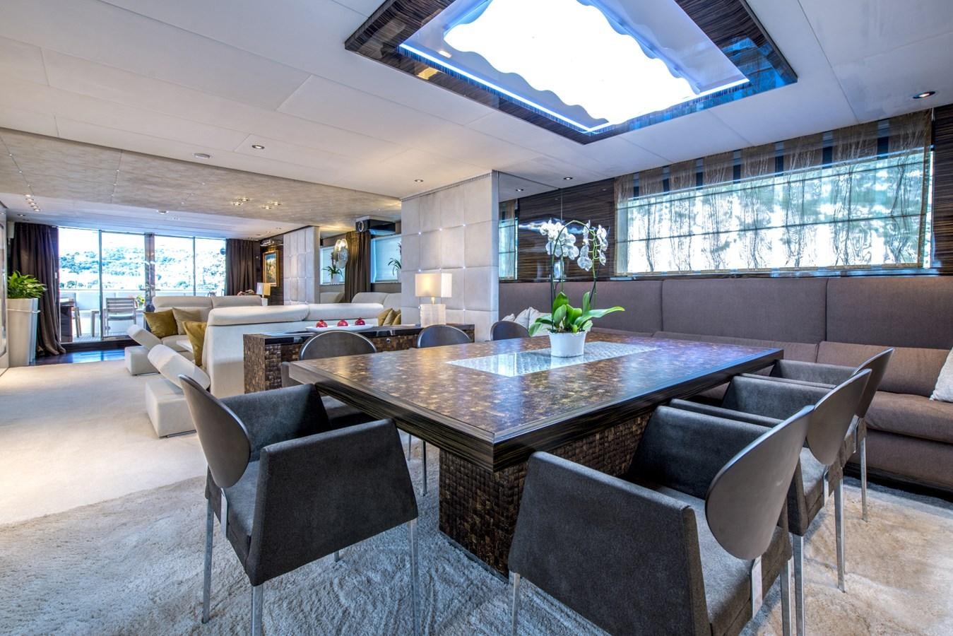 a large room with a table and chairs aboard TIAMAT Yacht for Sale