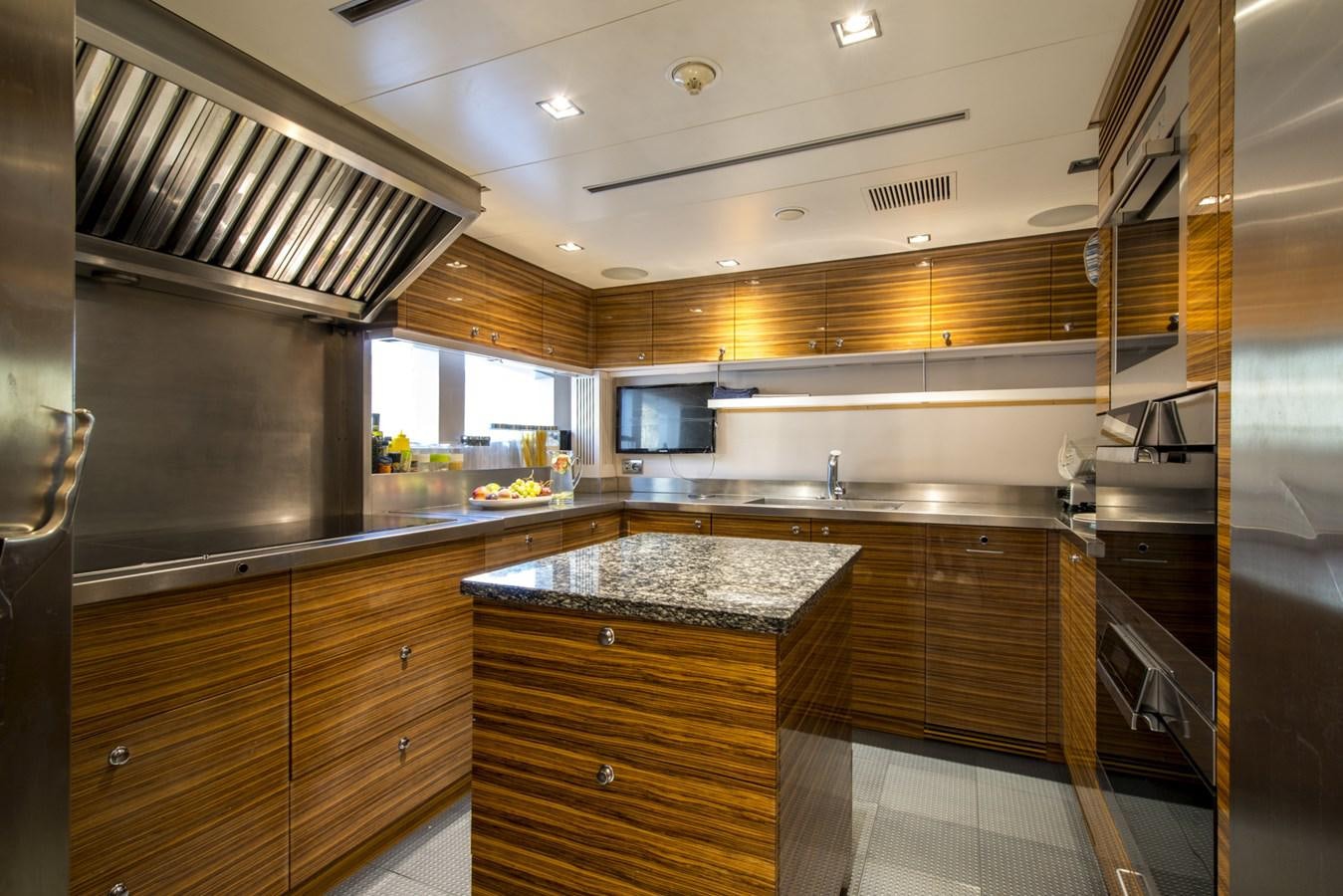 a kitchen with a large island aboard TIAMAT Yacht for Sale