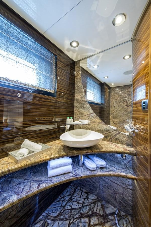 a bathroom with a sink and a large mirror aboard TIAMAT Yacht for Sale