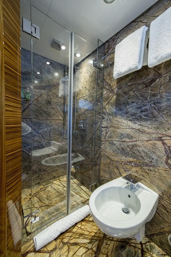a bathroom with a glass shower aboard TIAMAT Yacht for Sale