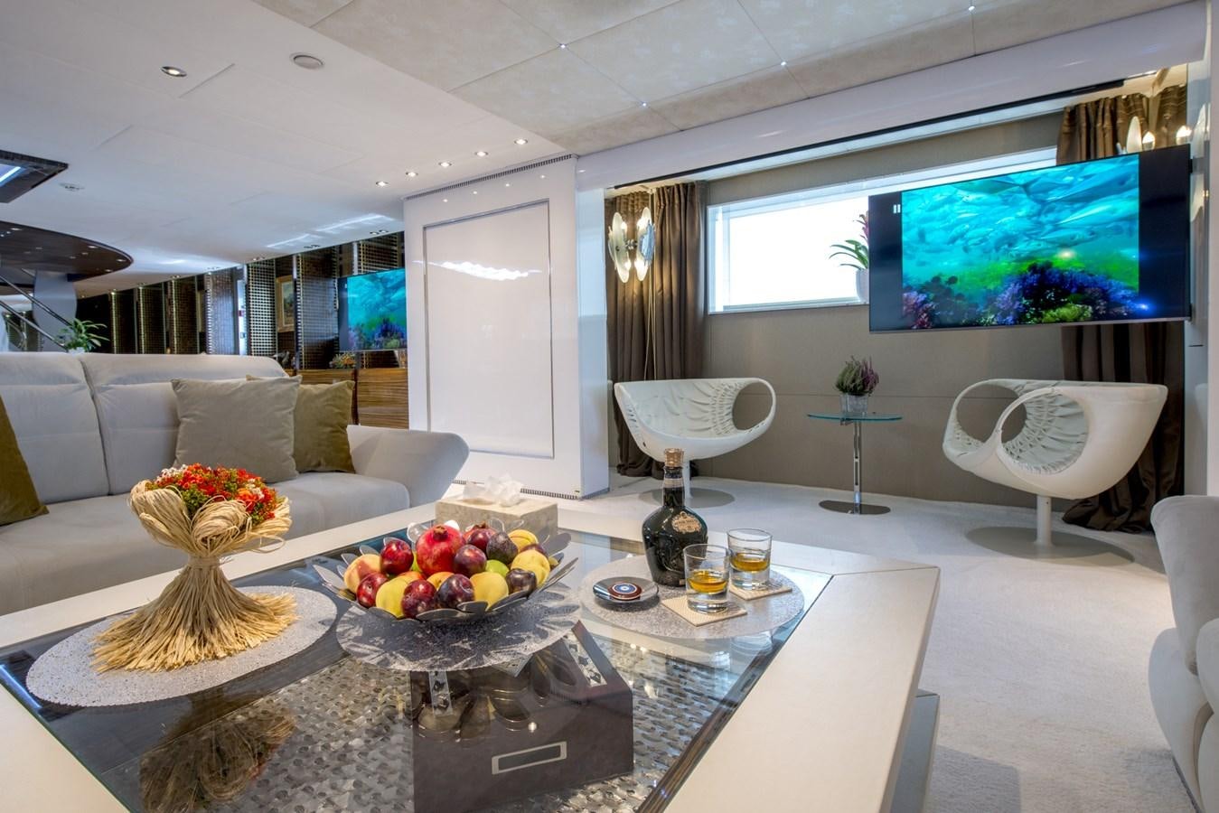 a living room with a large screen aboard TIAMAT Yacht for Sale