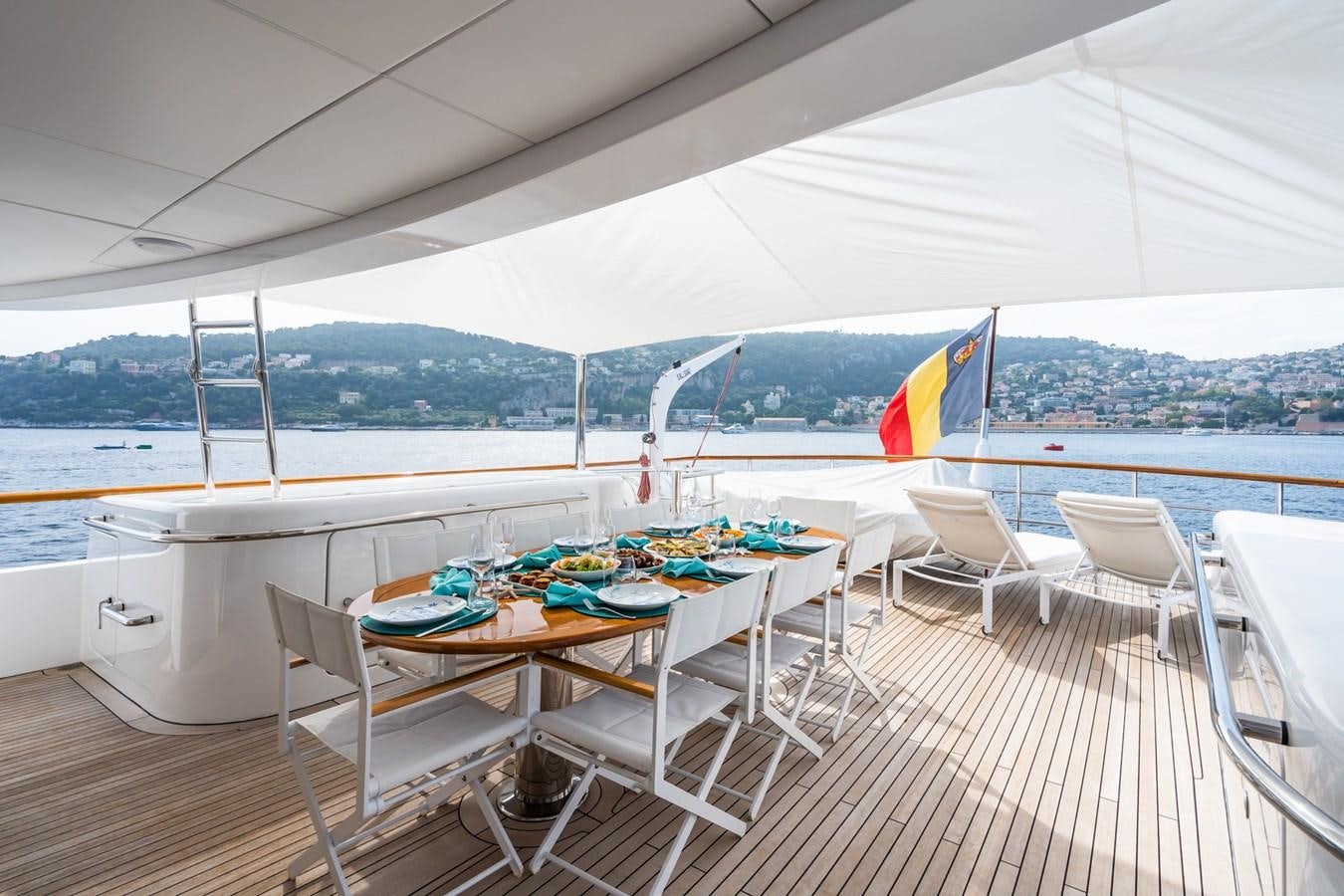 a table and chairs on a deck aboard CORNELIA Yacht for Sale