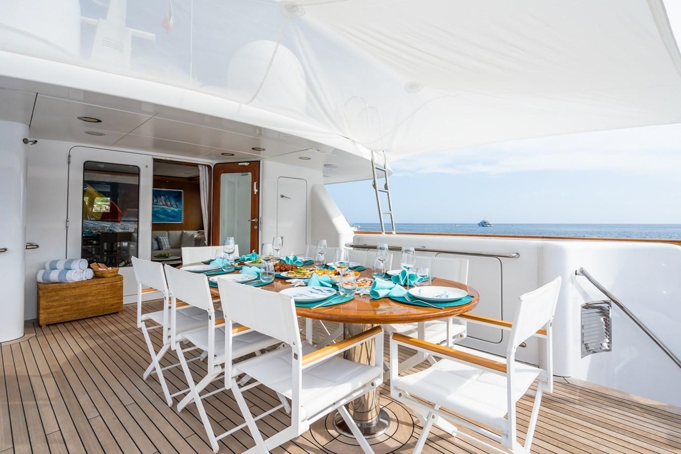 a dining area with a table and chairs aboard CORNELIA Yacht for Sale