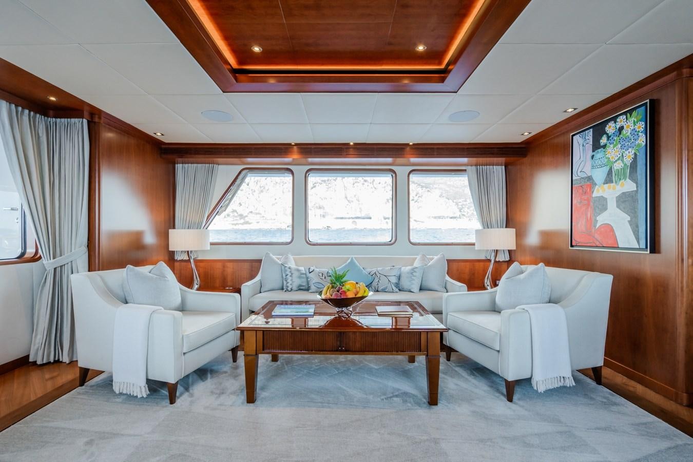 a living room with a couch and a coffee table aboard CORNELIA Yacht for Sale