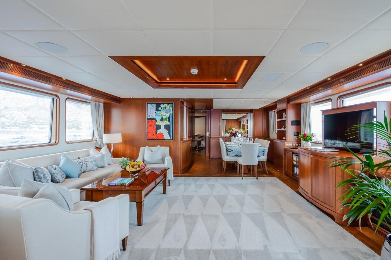 a living room with a large white table and chairs aboard CORNELIA Yacht for Sale
