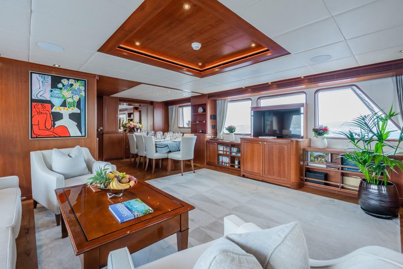 a living room with a table and chairs aboard CORNELIA Yacht for Sale