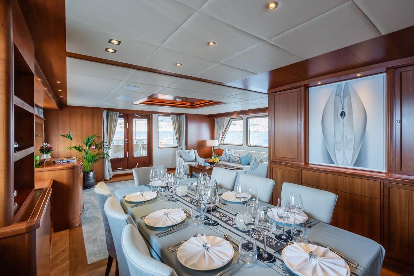 a dining room with a table set aboard CORNELIA Yacht for Sale