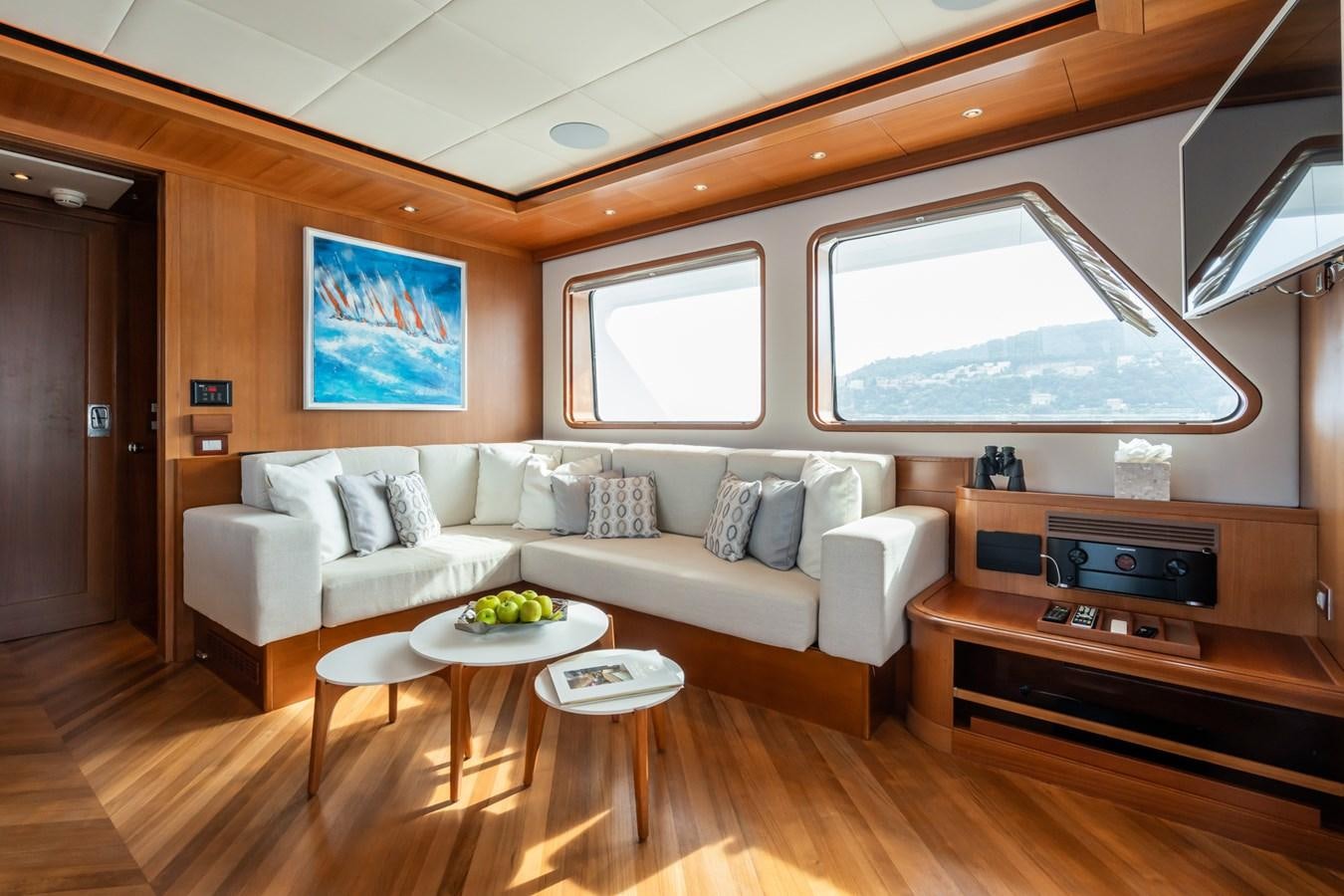 a living room with a couch and a table aboard CORNELIA Yacht for Sale