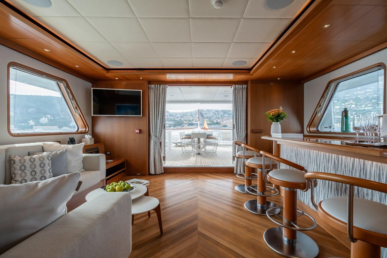 a living room with a large window aboard CORNELIA Yacht for Sale