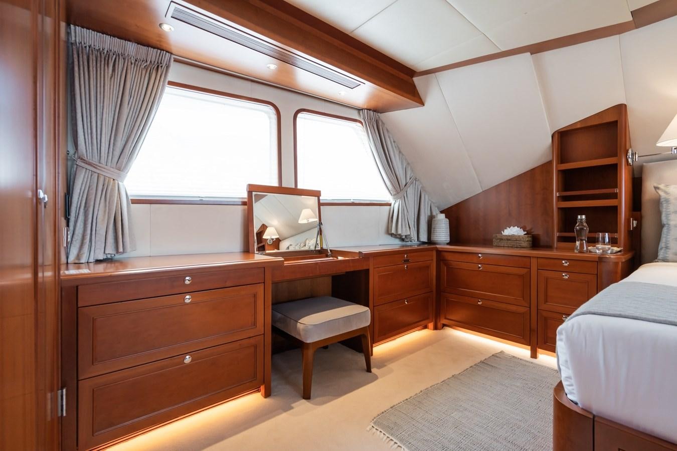 a bedroom with a desk and a chair aboard CORNELIA Yacht for Sale