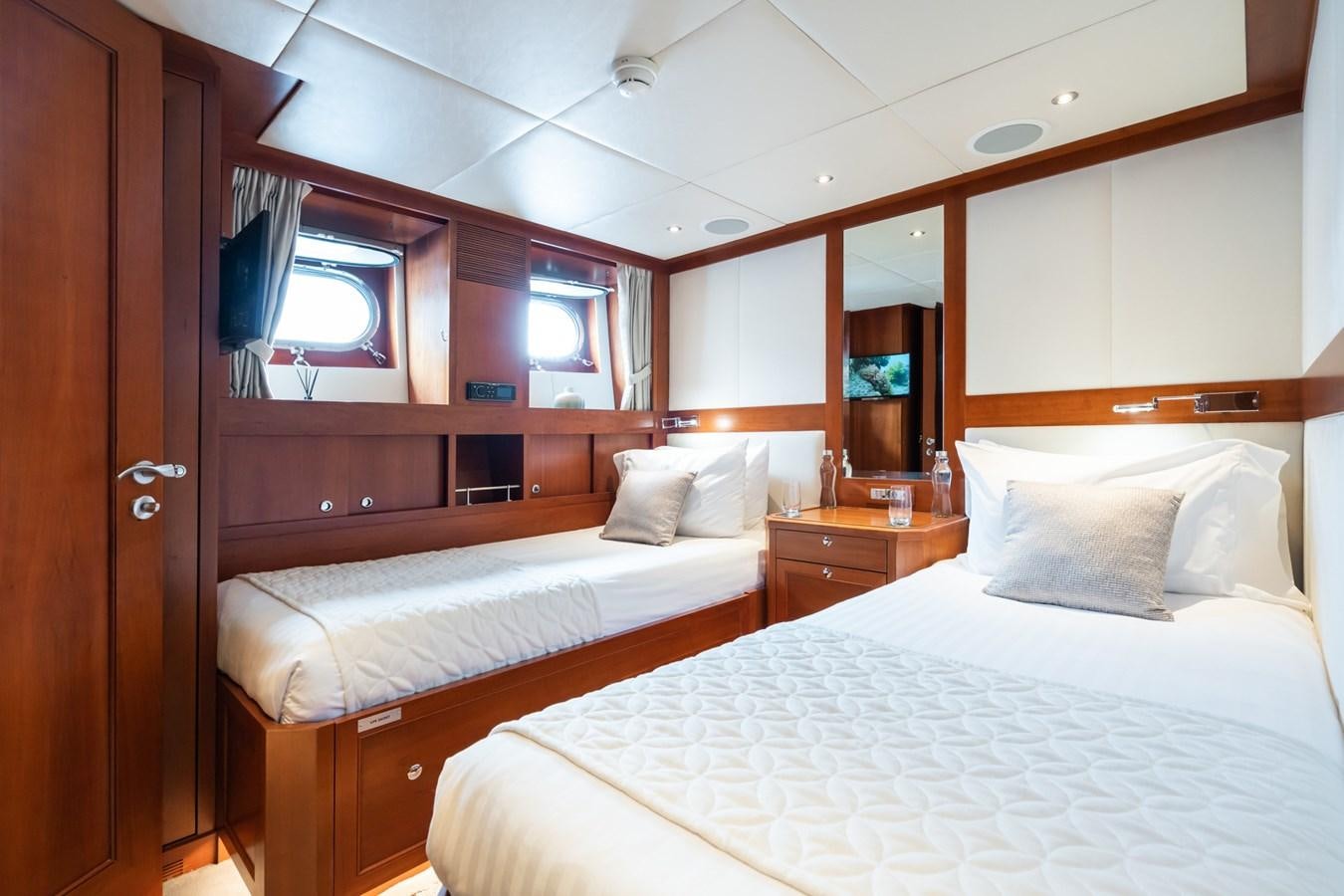 a couple of beds in a room aboard CORNELIA Yacht for Sale
