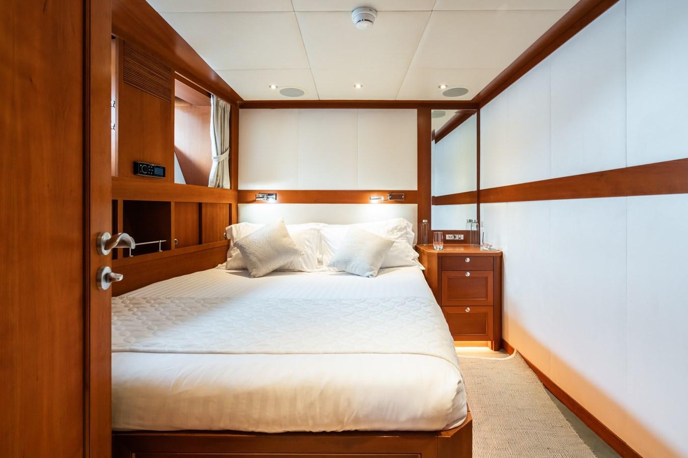 a bed with white sheets aboard CORNELIA Yacht for Sale