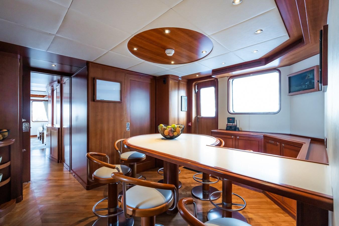 a large kitchen with a dining table aboard CORNELIA Yacht for Sale