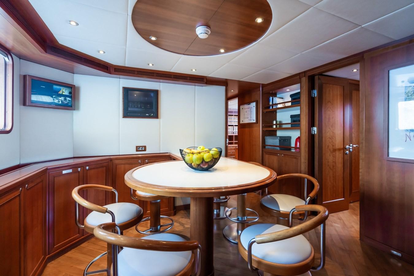 a kitchen with a table and chairs aboard CORNELIA Yacht for Sale