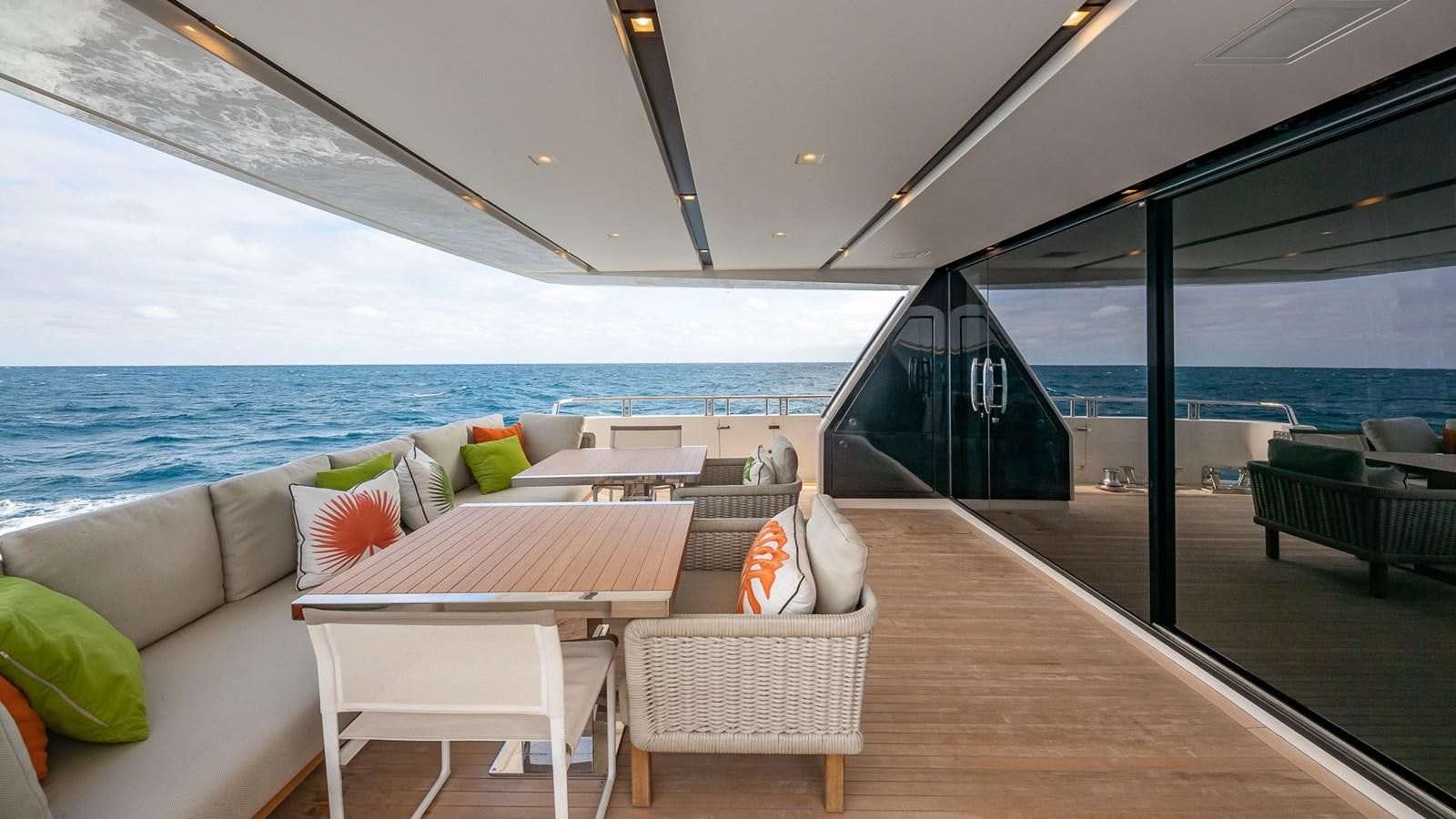 a room with a couch and a table and chairs aboard XWAVE Yacht for Sale