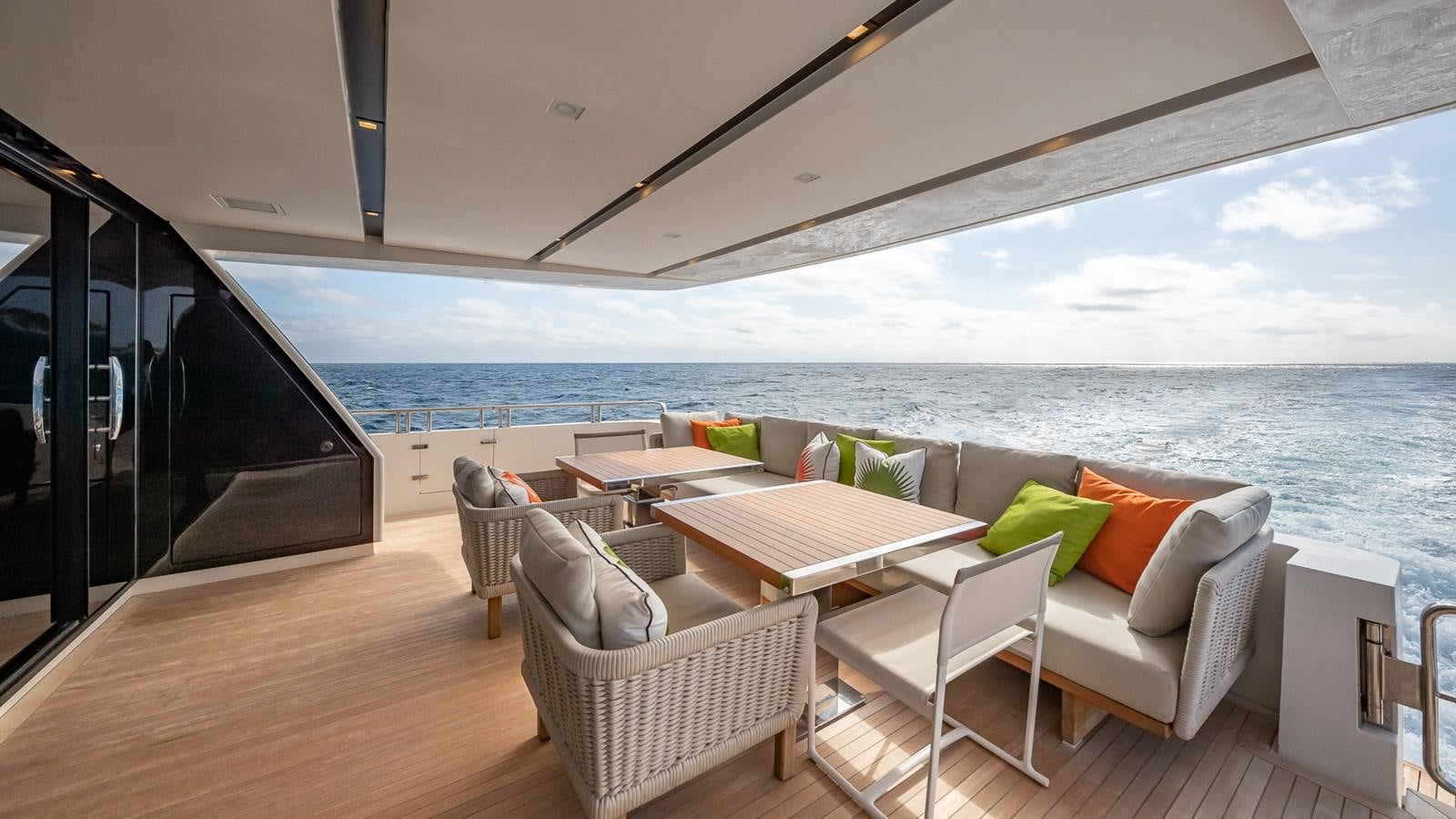 a room with a table chairs and a large body of water aboard XWAVE Yacht for Sale