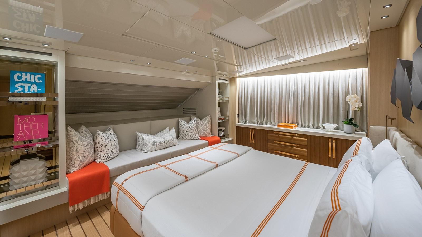 a bedroom with a bed and a desk aboard XWAVE Yacht for Sale