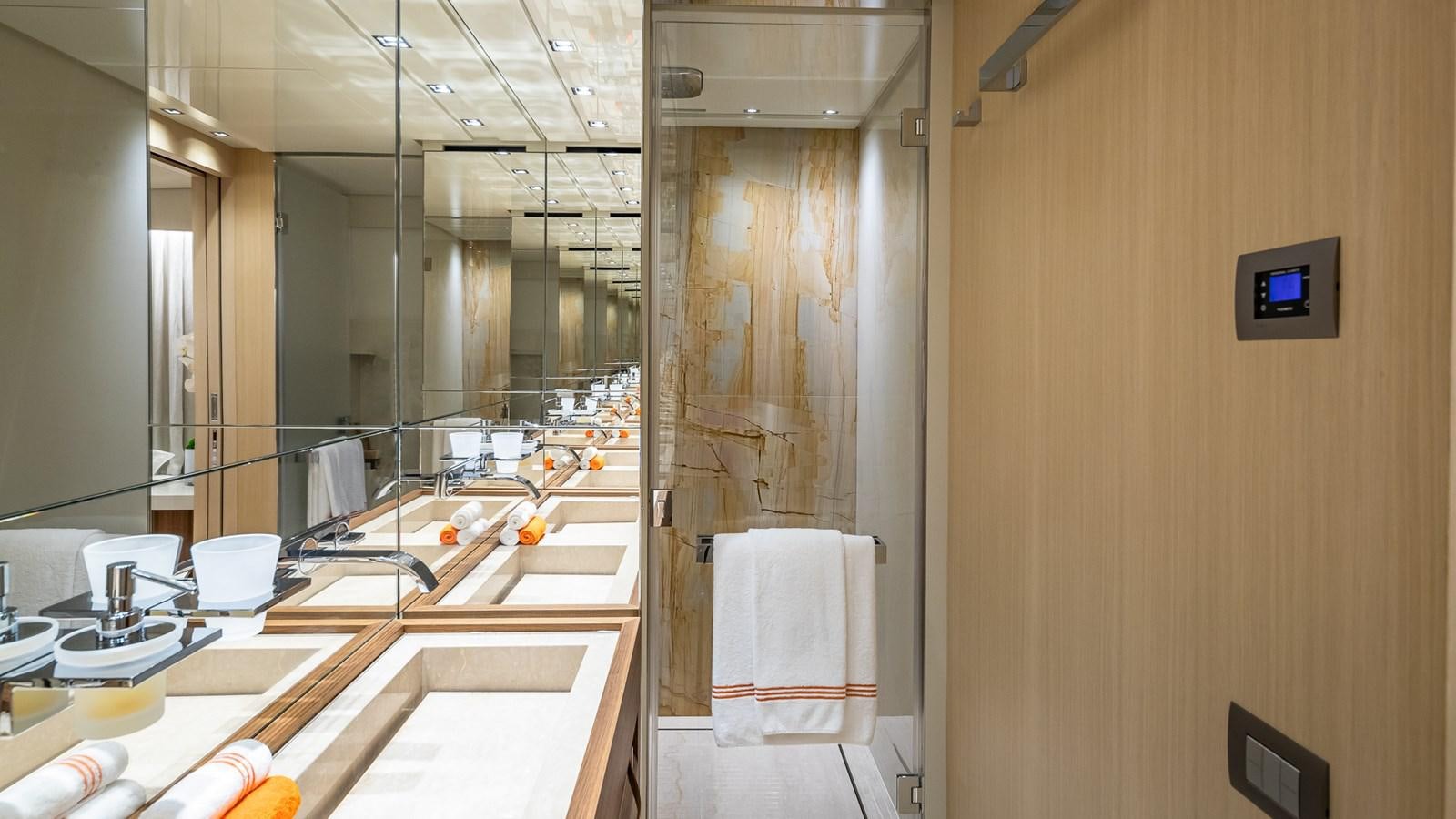a bathroom with a large mirror aboard XWAVE Yacht for Sale