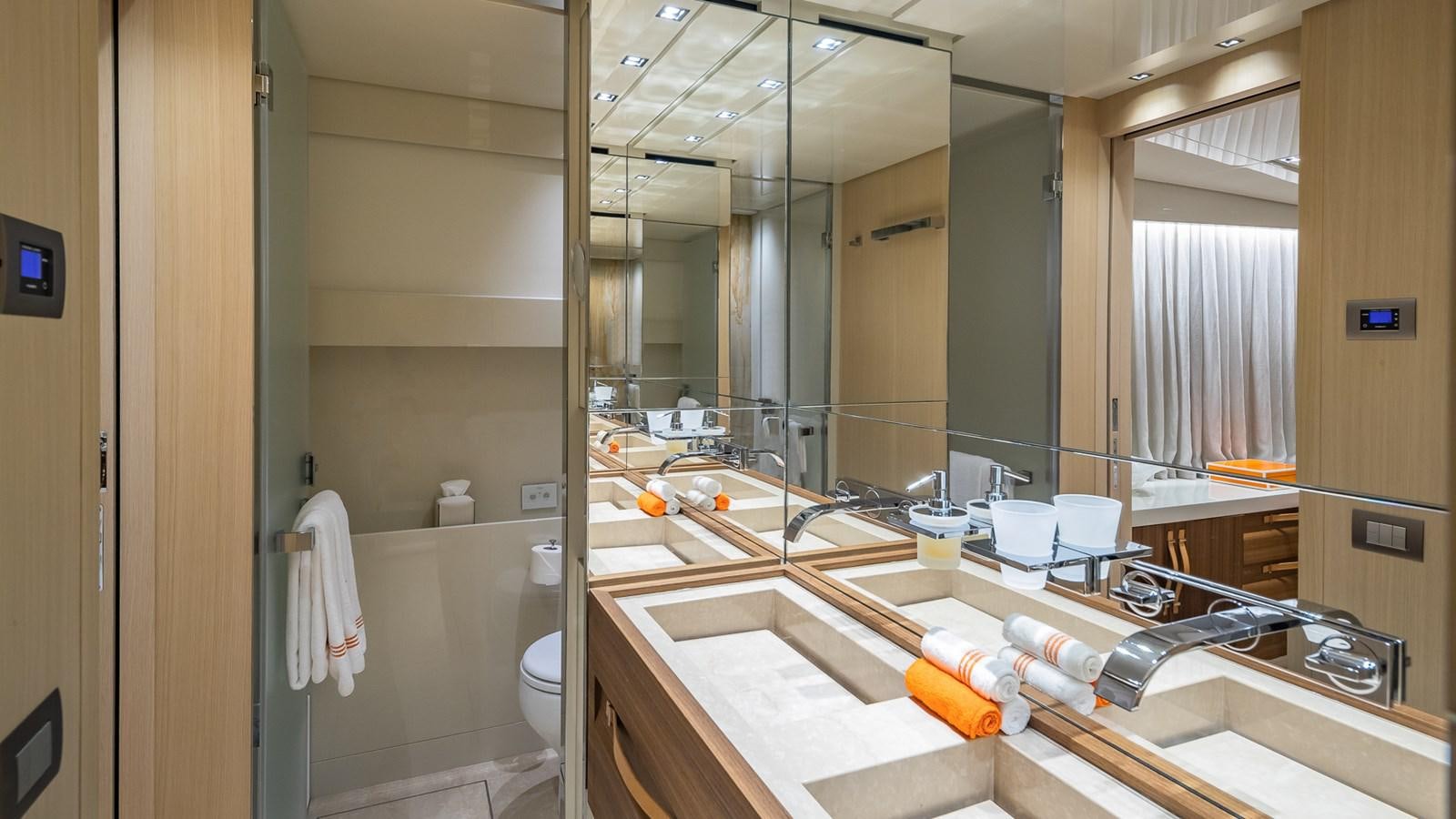 a bathroom with a large mirror aboard XWAVE Yacht for Sale