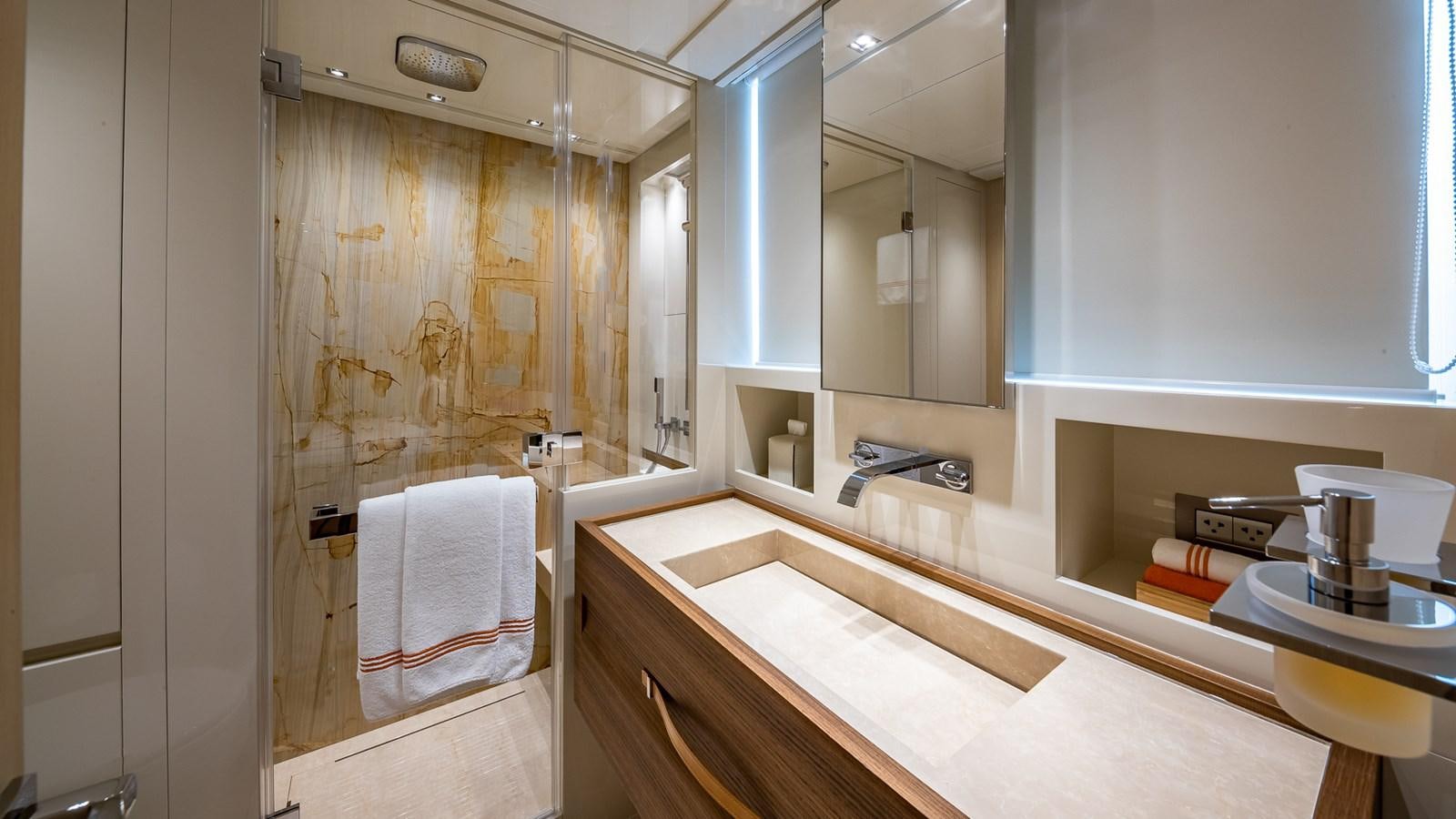 a bathroom with a shower and sink aboard XWAVE Yacht for Sale