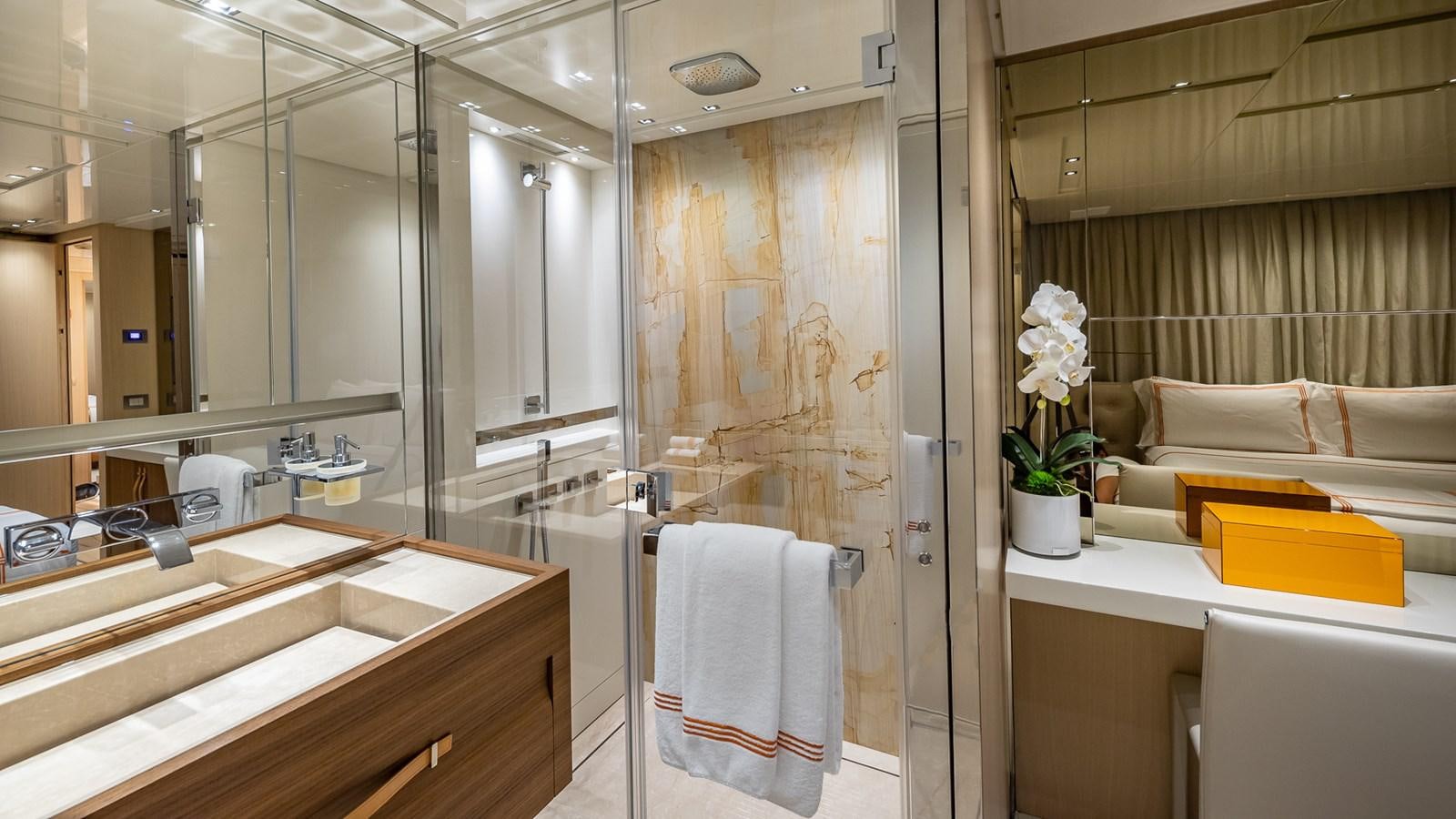 a bathroom with a glass shower aboard XWAVE Yacht for Sale