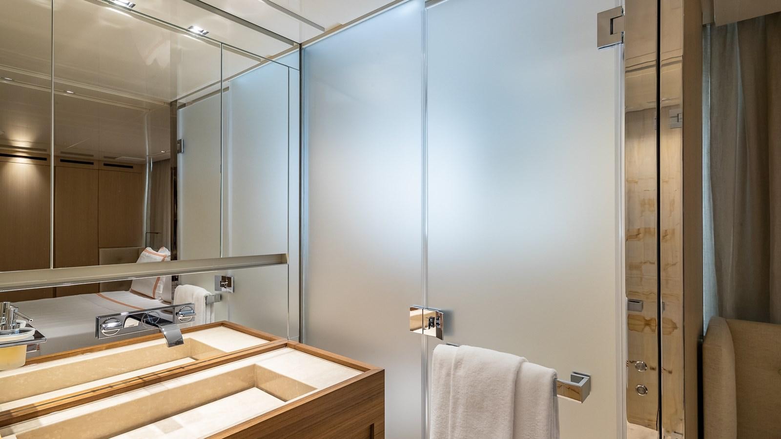 a bathroom with a large mirror aboard XWAVE Yacht for Sale