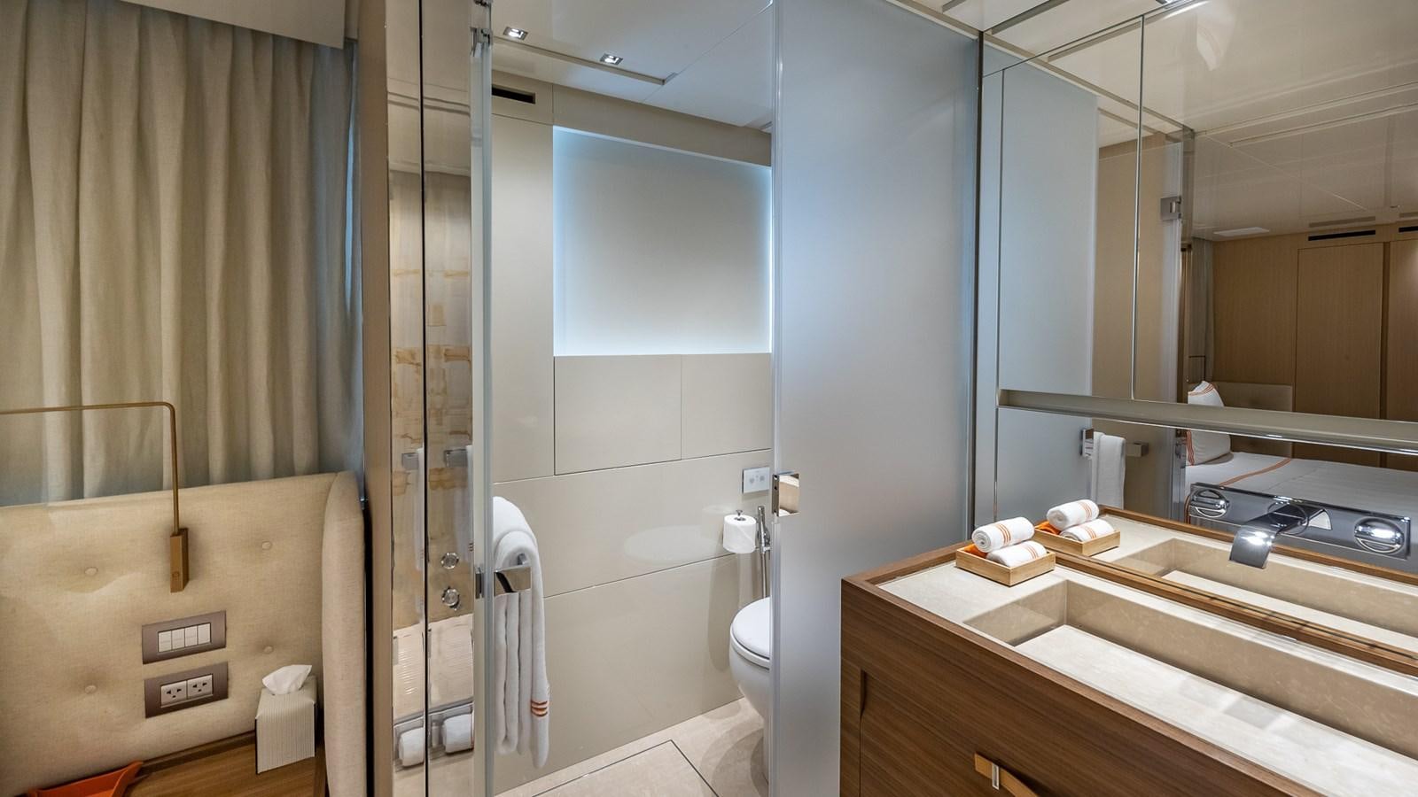a bathroom with a glass shower aboard XWAVE Yacht for Sale