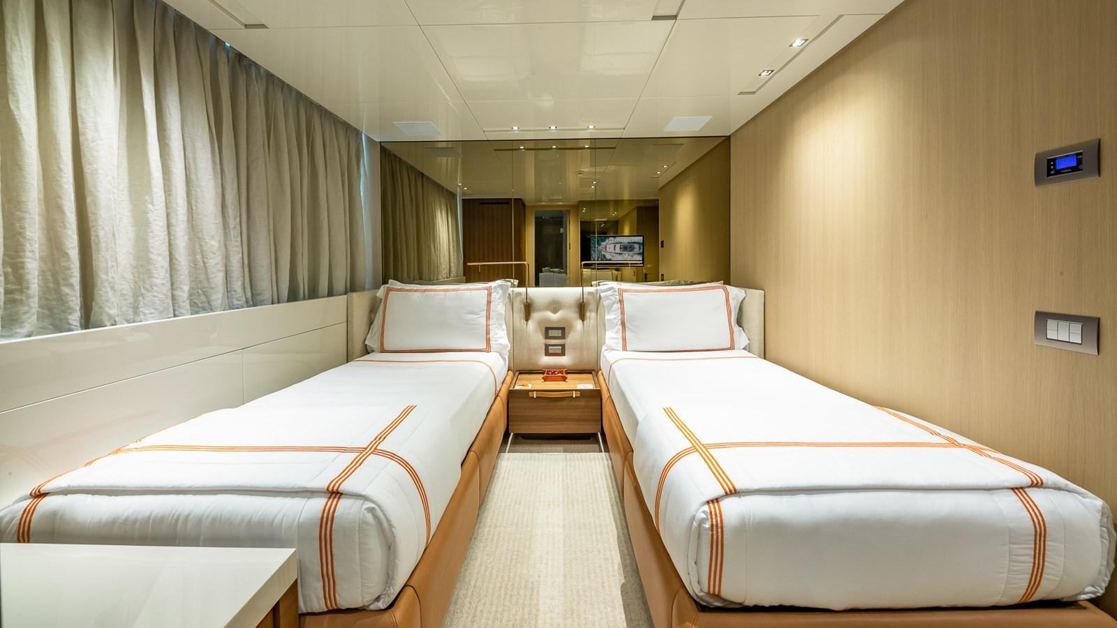 a room with beds and a window aboard XWAVE Yacht for Sale