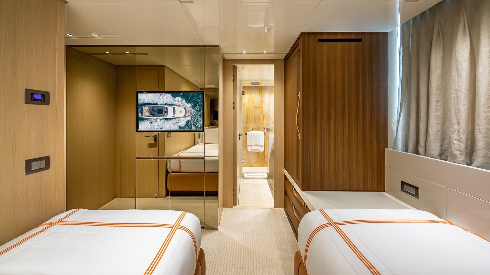 a room with a bed and a tv aboard XWAVE Yacht for Sale