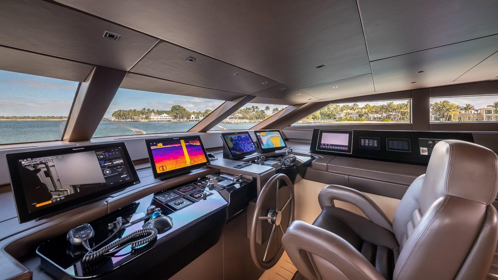 inside of a car with many monitors and screens aboard XWAVE Yacht for Sale