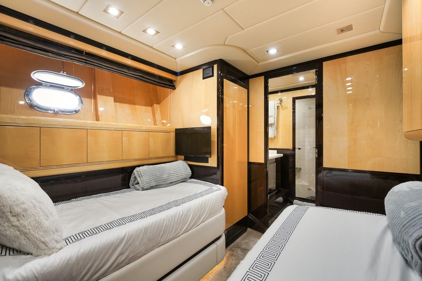 a room with a bed and a television aboard TATAMI Yacht for Sale