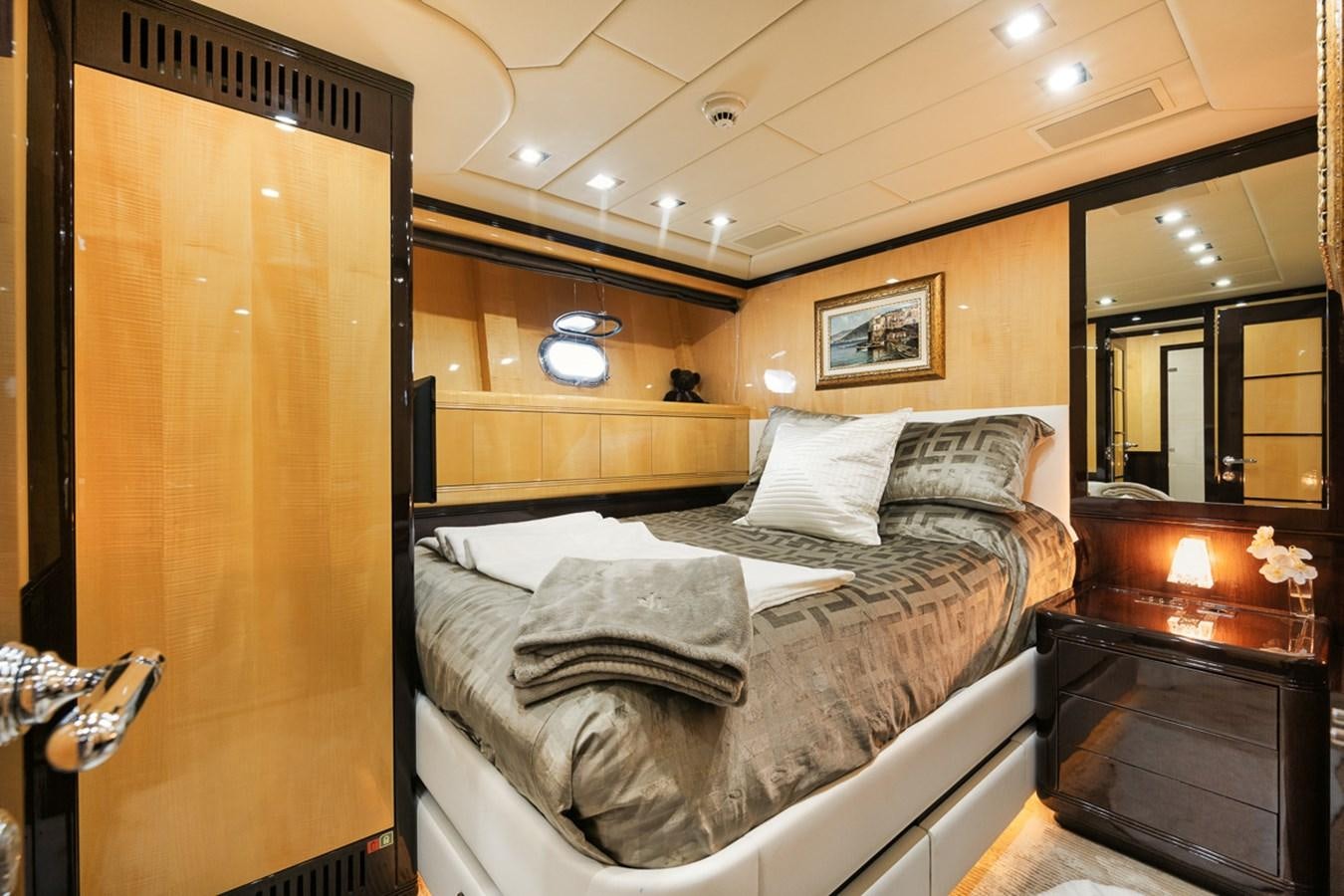 a bedroom with a bed and a wood door aboard TATAMI Yacht for Sale