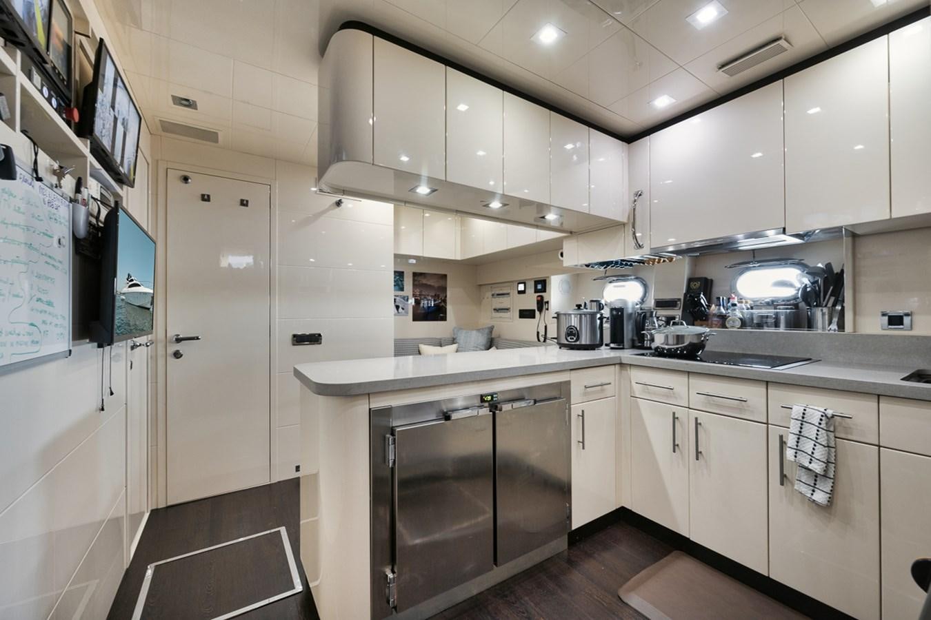 a kitchen with white cabinets aboard TATAMI Yacht for Sale