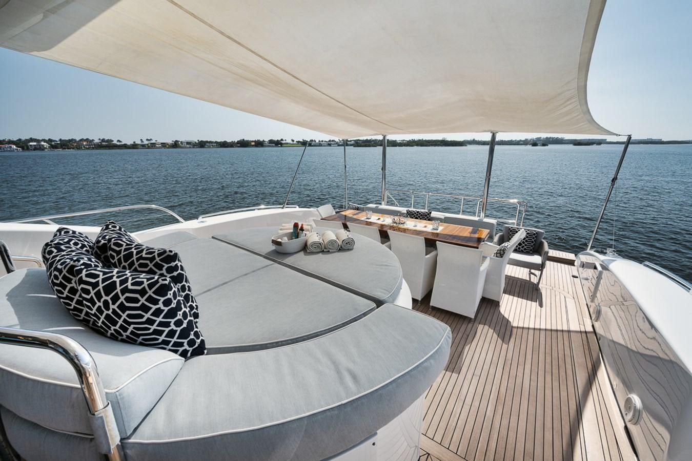 a deck with a view of the ocean and a beach aboard TATAMI Yacht for Sale