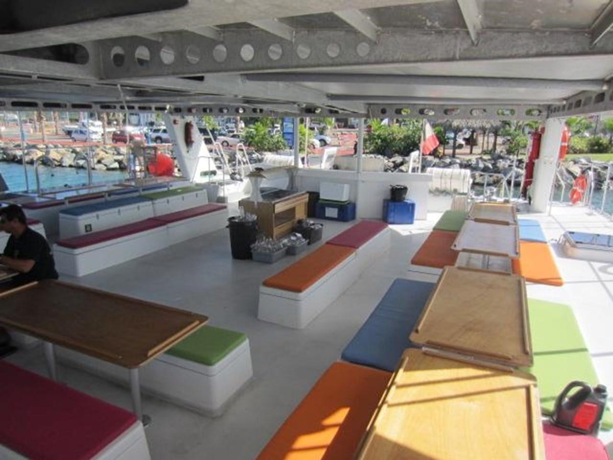 a room with tables and chairs aboard ECOLORATO Yacht for Sale