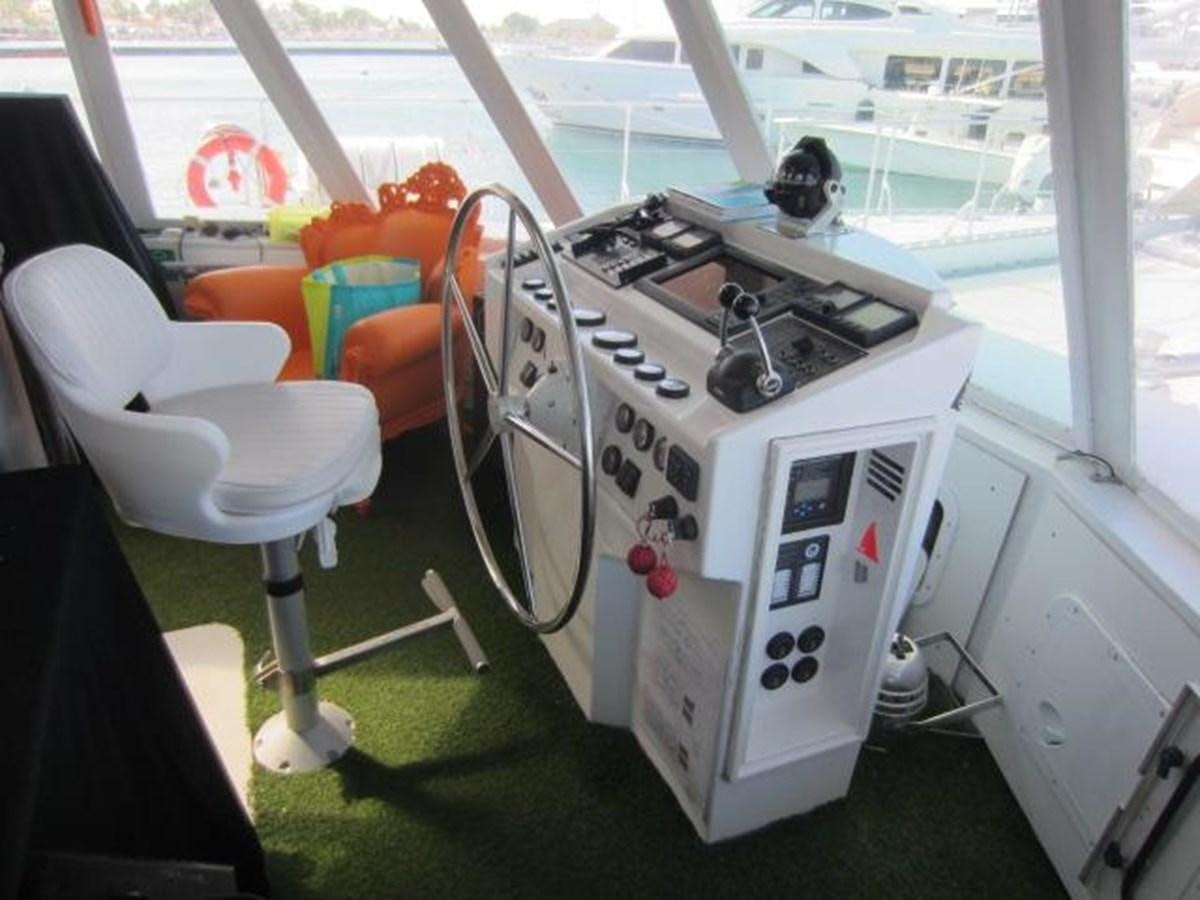 a room with a machine and chairs aboard ECOLORATO Yacht for Sale