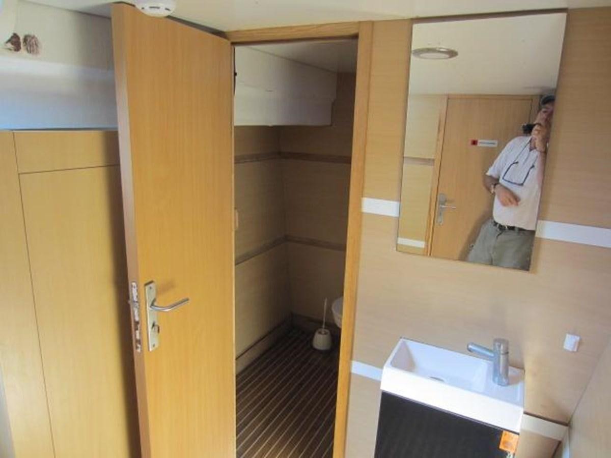 a person taking a picture of himself in a bathroom mirror aboard ECOLORATO Yacht for Sale
