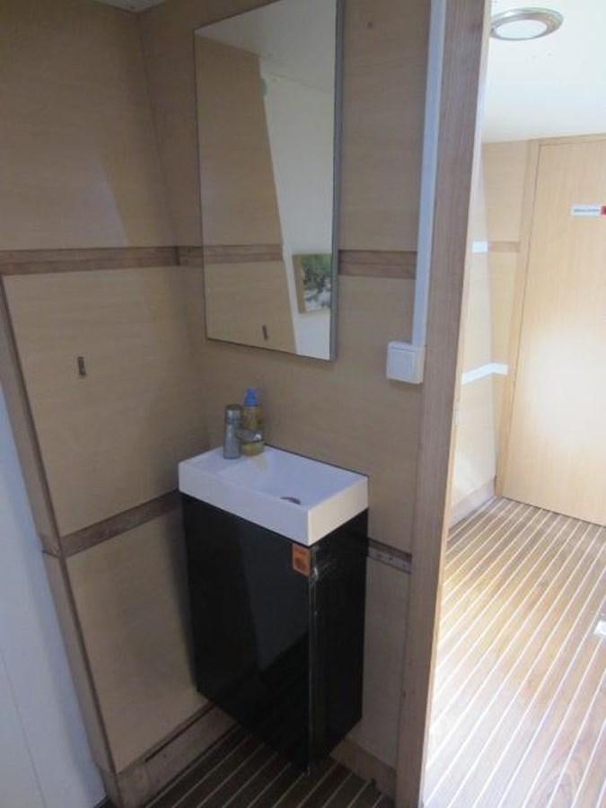 a bathroom with a sink and mirror aboard ECOLORATO Yacht for Sale
