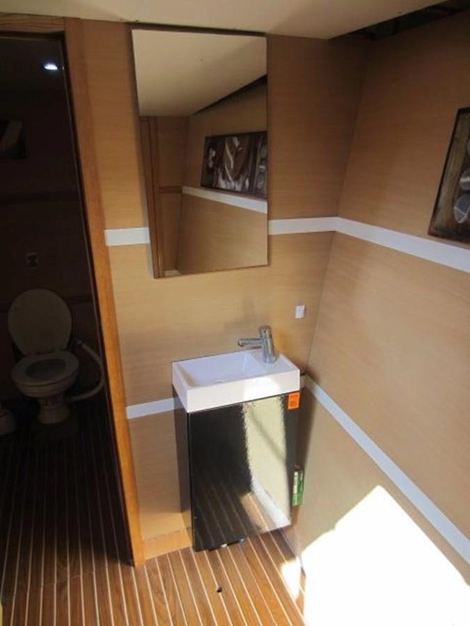 a bathroom with a sink and a mirror aboard ECOLORATO Yacht for Sale