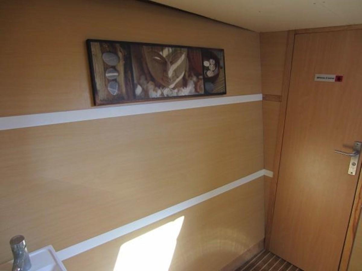 a wooden cabinet with pictures on it aboard ECOLORATO Yacht for Sale