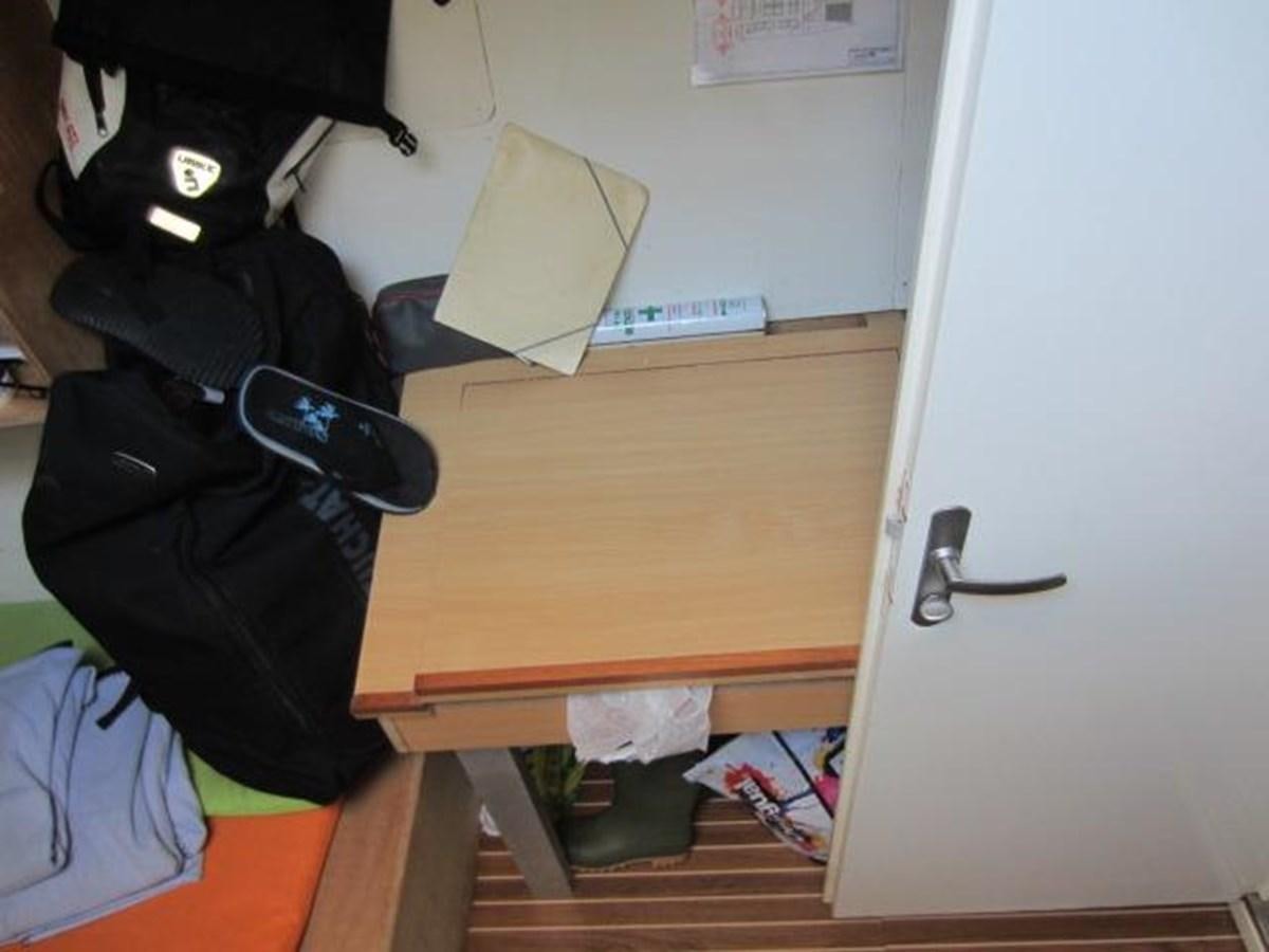 a desk with a laptop and a backpack aboard ECOLORATO Yacht for Sale