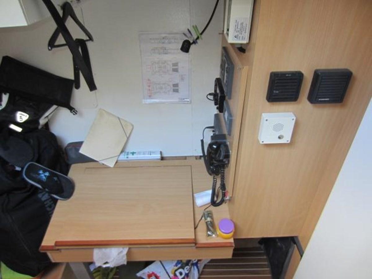 a desk with a laptop and other office items on it aboard ECOLORATO Yacht for Sale