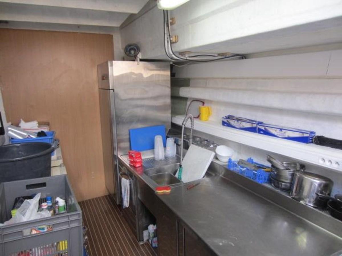 a kitchen with a stainless steel sink aboard ECOLORATO Yacht for Sale