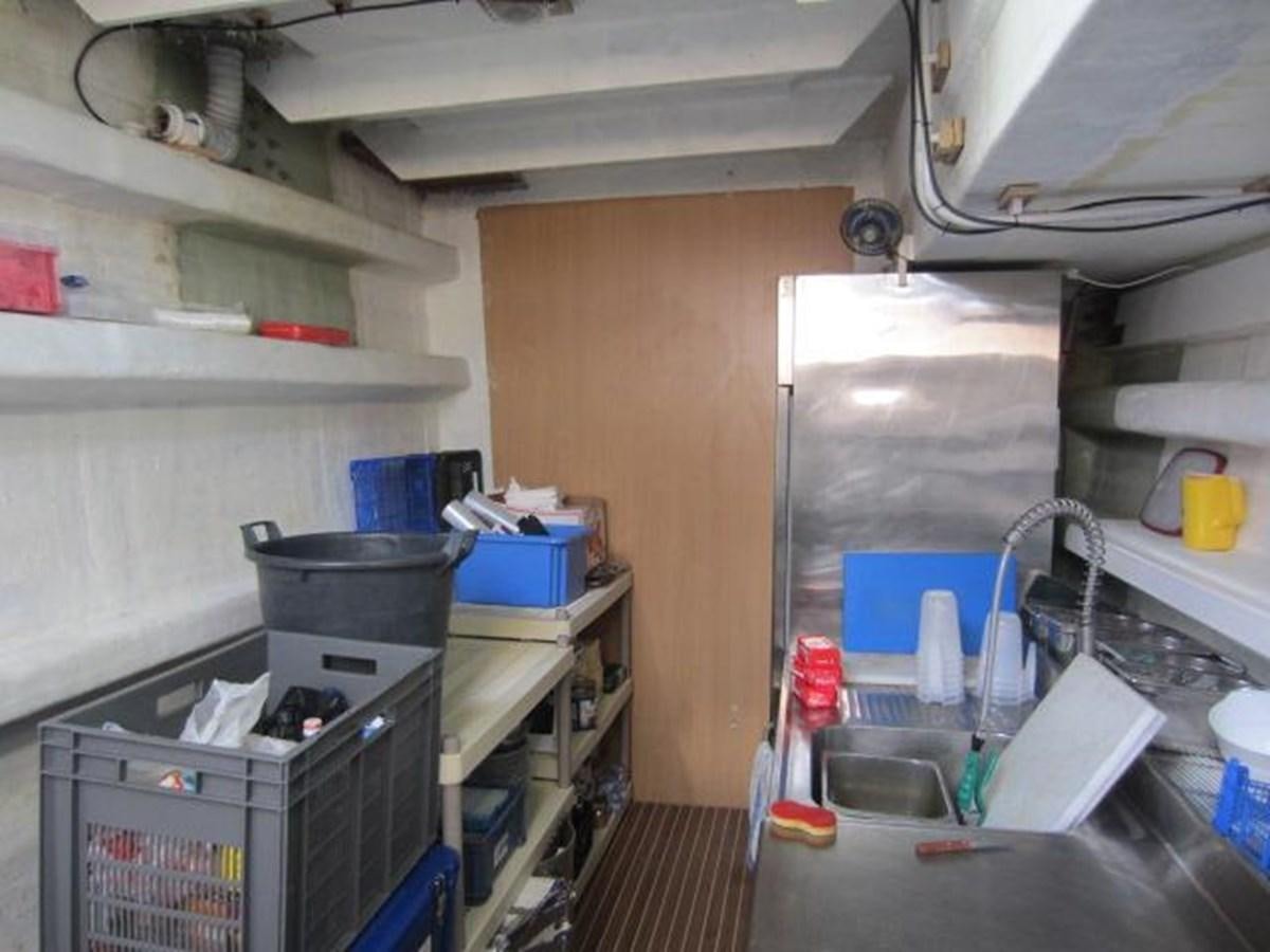a kitchen with a sink and shelves aboard ECOLORATO Yacht for Sale